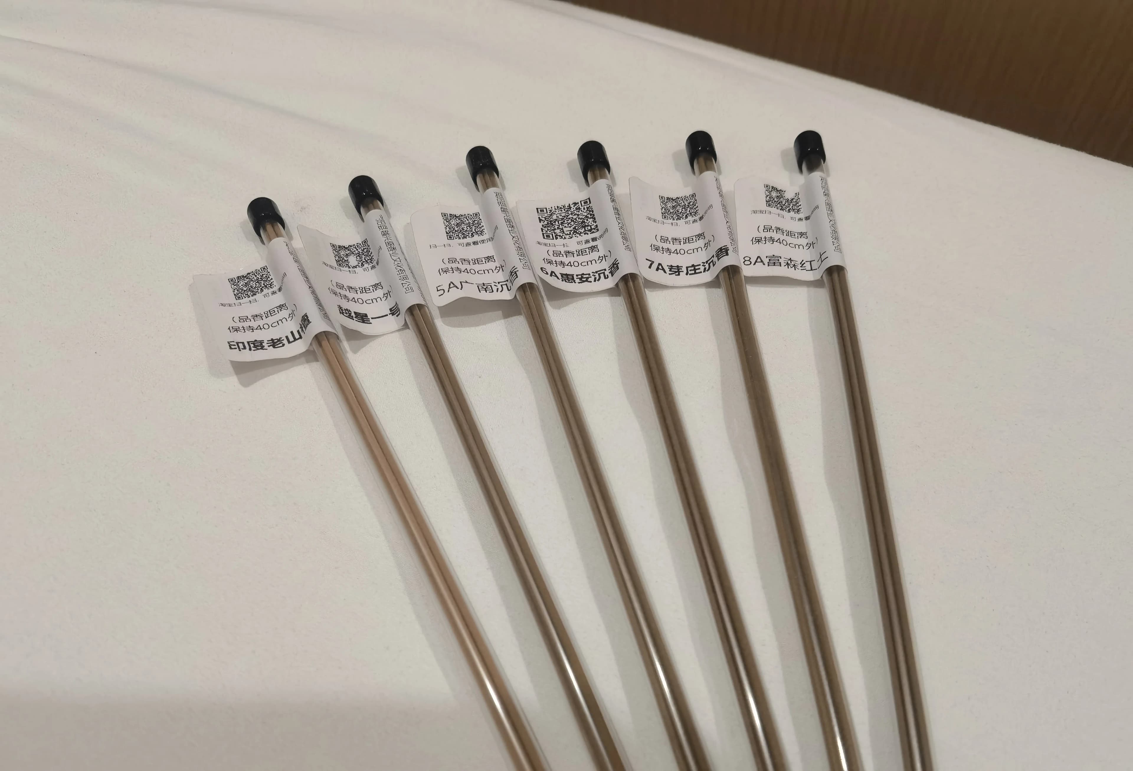 Six labeled incense samples from Nanyue Incense arranged on a dark surface